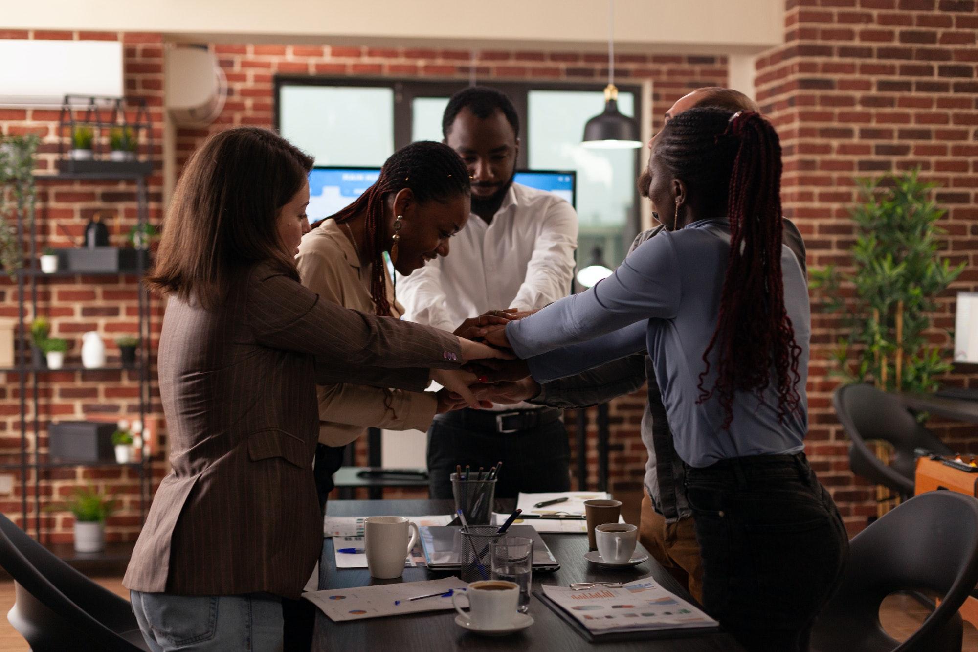 Excited successful multi-ethnic businesspeople celebrating marketing partnership